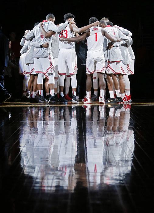 Sports Feature - 3rd place   - The Ohio State Buckeyes huddle up during player introductions before their game against the Miami (Oh) Redhawks at Value City Arena in Columbus. (Barbara J. Perenic / The Columbus Dispatch)